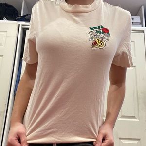 Tan graphic tee with tiger print on it